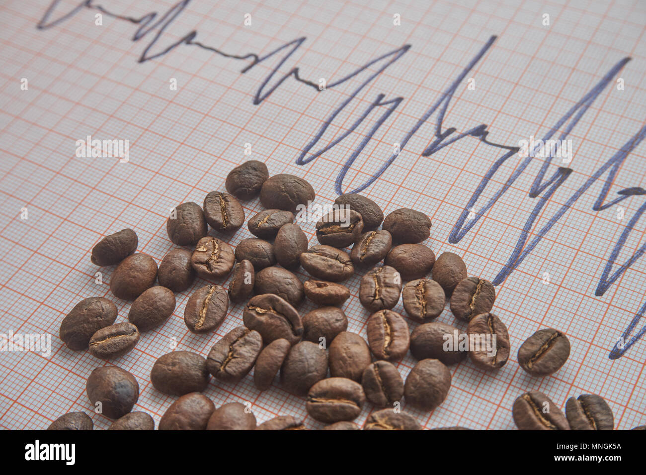 Loose Roasted Coffee Beans On An ECG Tracing Showing An Increased Heart Loose Roasted Coffee Beans On An ECG Tracing Showing An Increased Heart